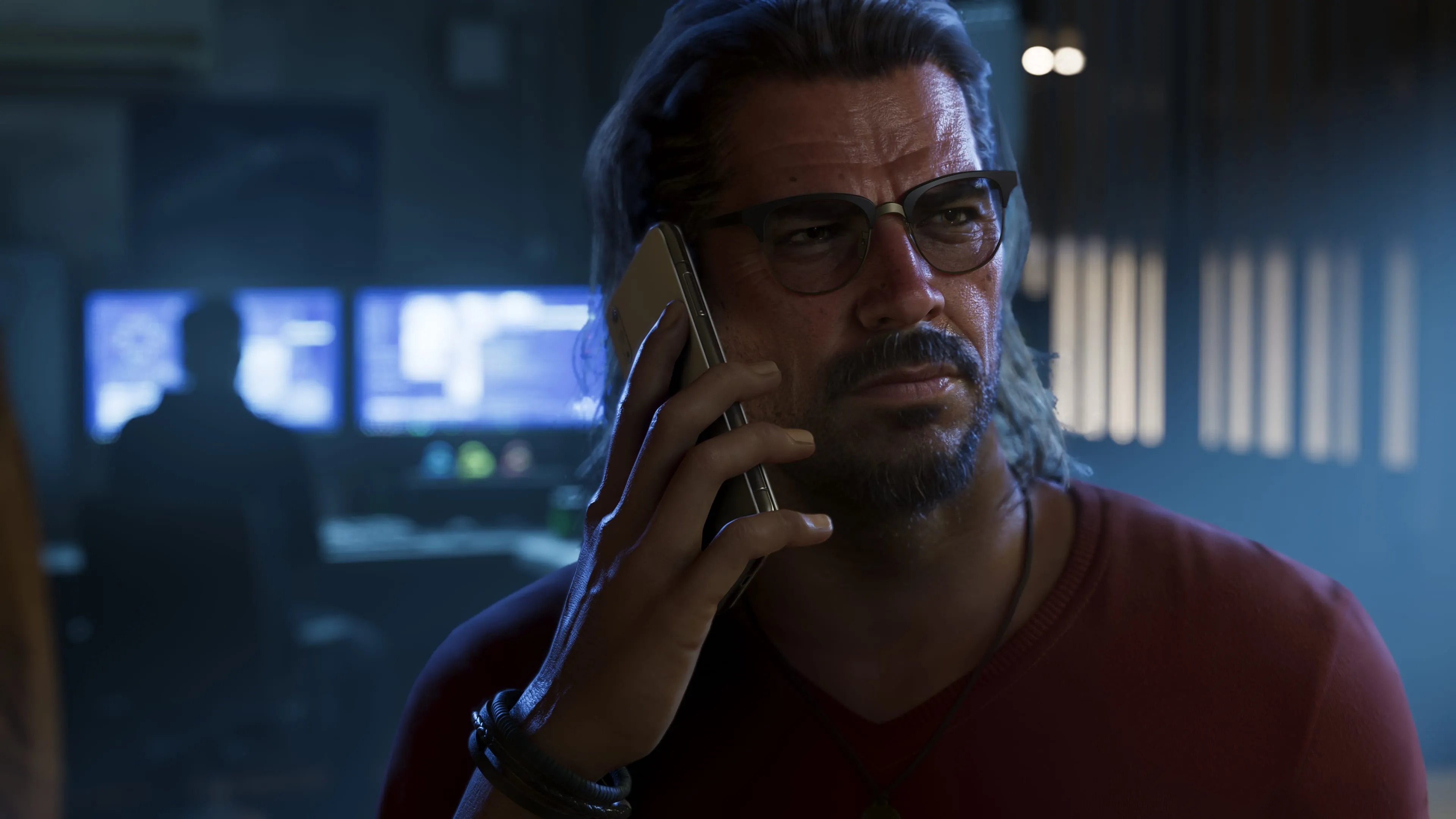 GTA 6 Raul Bautista on the phone in a dim surveillance room